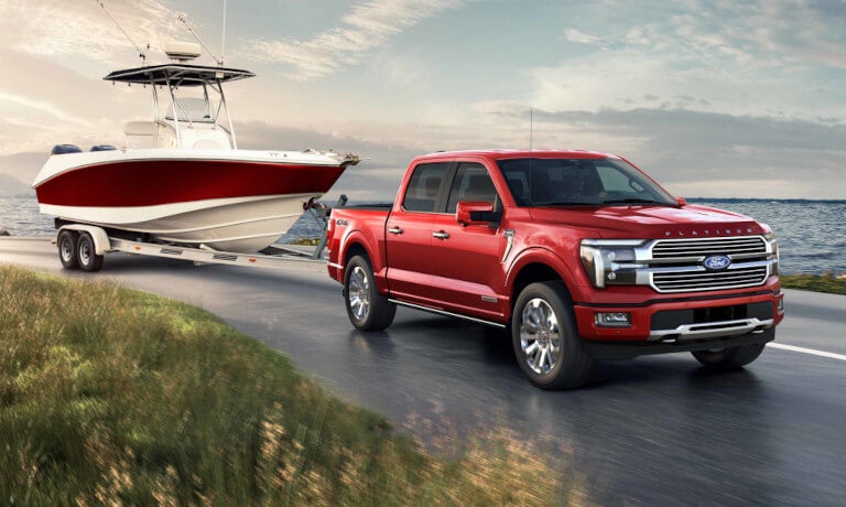 2025 Ford F-150 towing a boat by a lake